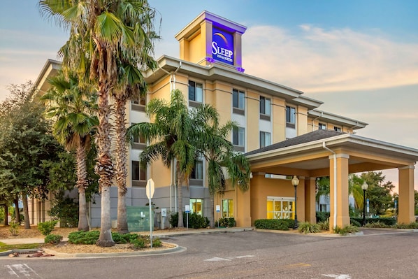 Welcome to Sleep Inn & Suites, featuring a modern architectural design and beautifully landscaped surroundings.