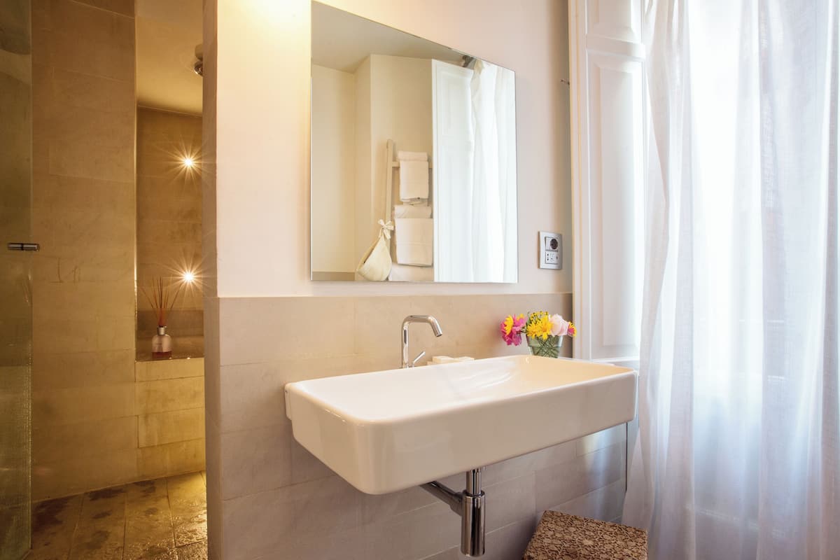 shower, hair dryer, slippers, towels