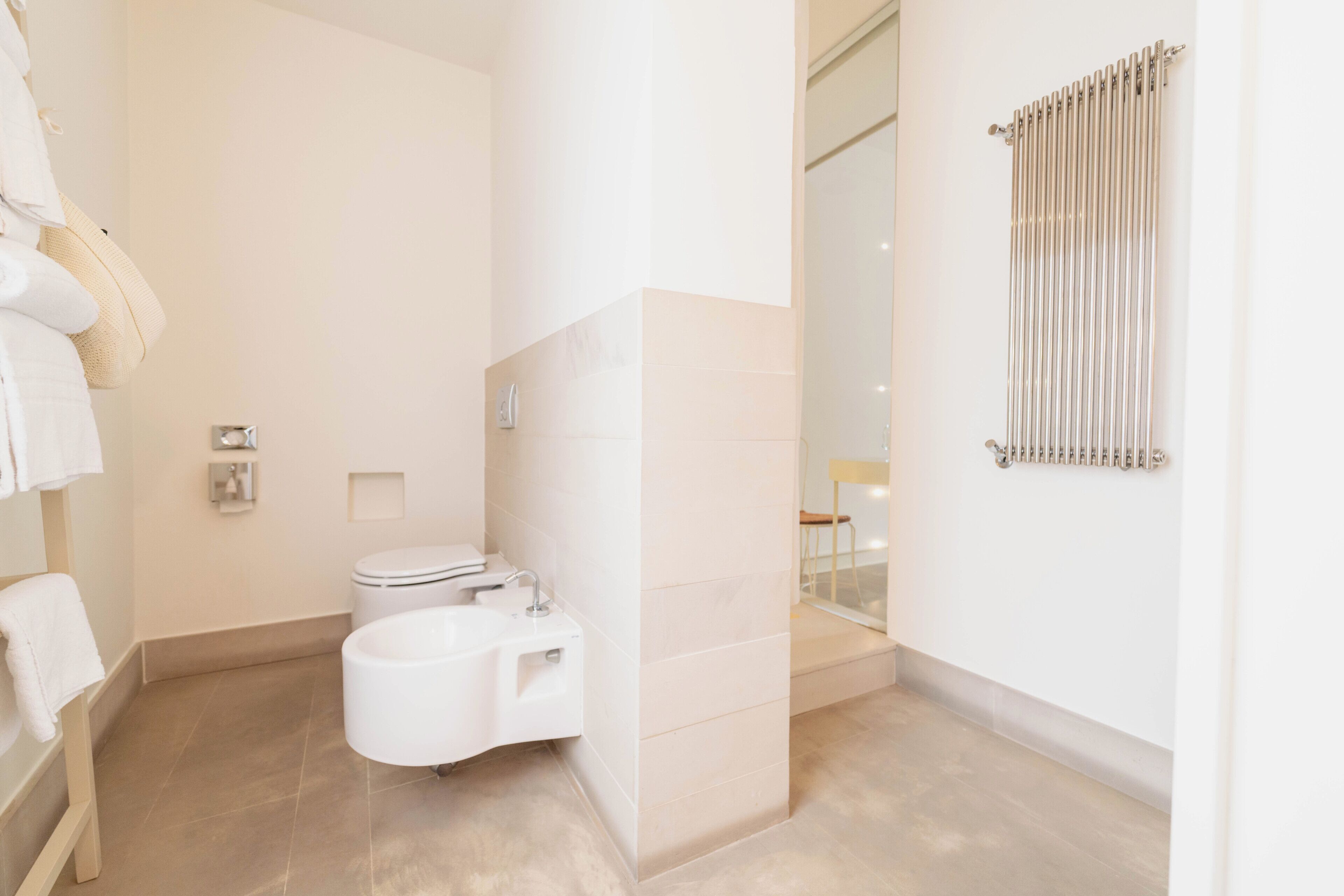 A modern bathroom with a toilet, sink, and bathtub.