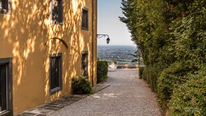 A pathway leading to a building with a view of the city.