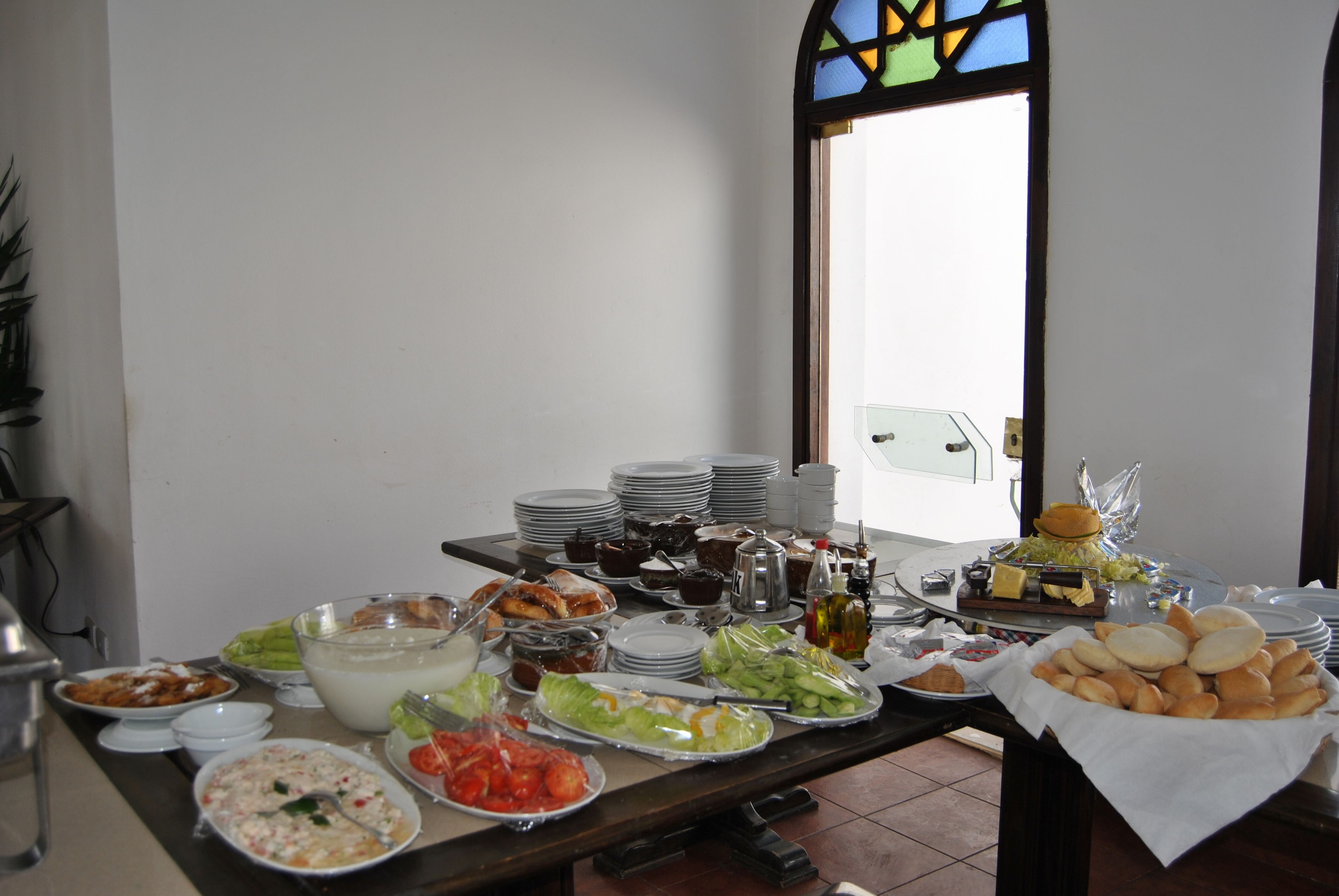 A buffet table with various food items and dishes.