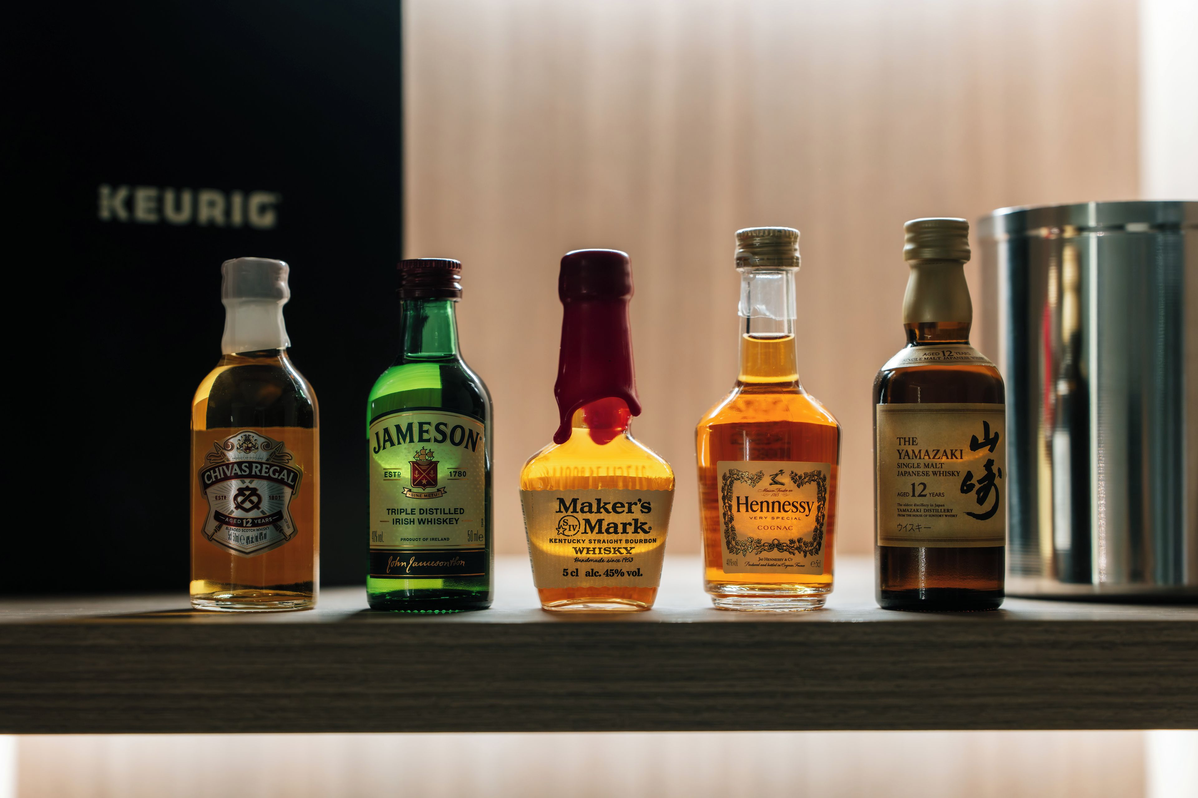 A selection of whiskey bottles on a shelf.