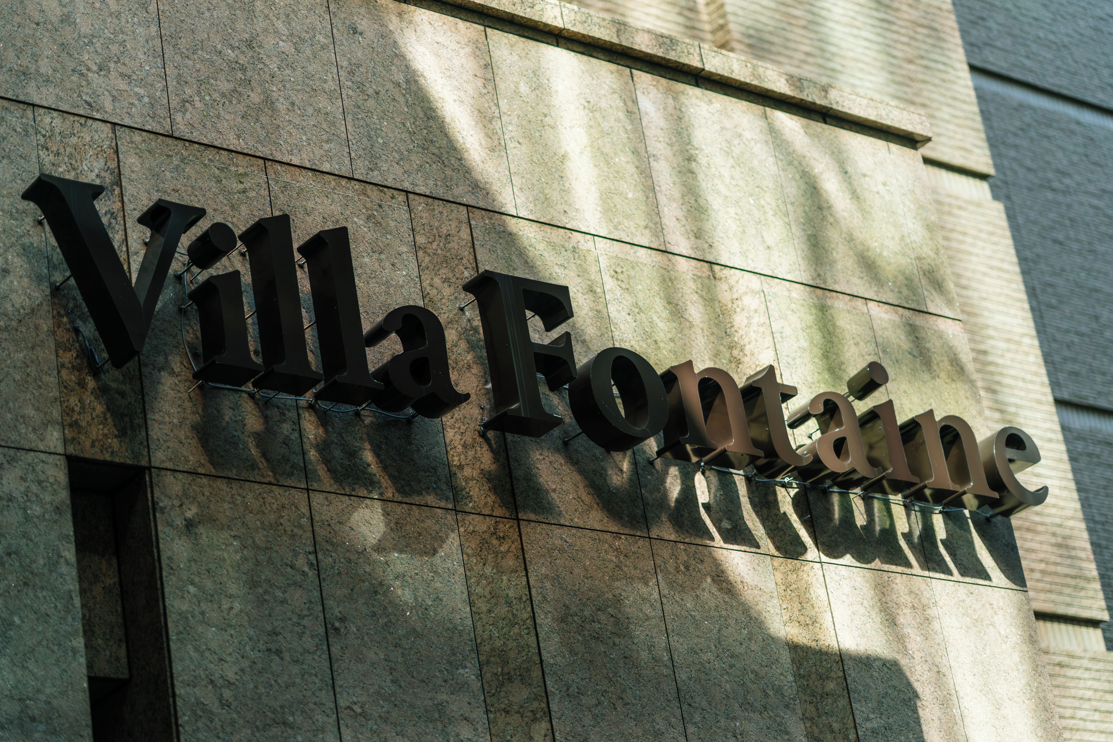 Fachada de un edificio con el nombre 'Villa Fontana' exhibido en letras grandes y llamativas.