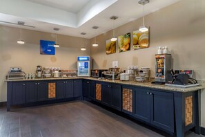 A modern kitchen area with a coffee station, a refrigerator, and a microwave. - Comfort Suites Buda - Austin South (Buda)