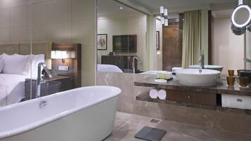 A modern bathroom with a large bathtub, a vanity with a sink, and a mirror.