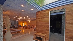 A spacious indoor area with a wooden wall, a glass door leading outside, and several lounge chairs. - Tornácos Panzió (HEGYKÖ)