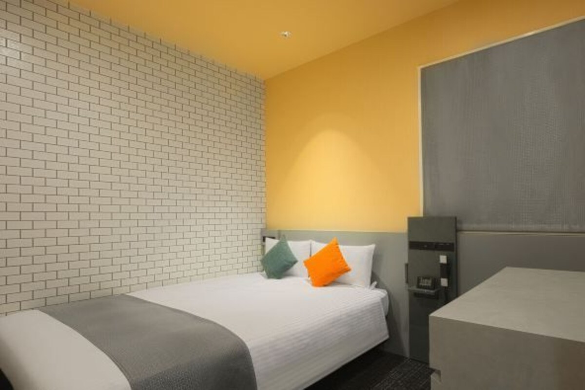 Cortinas opacas, tabla de planchar con plancha, ropa de cama