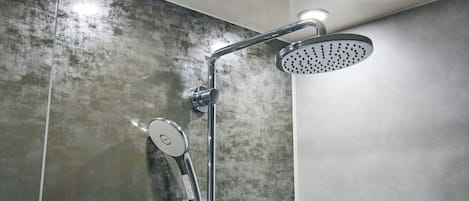 Una ducha moderna con cabezal de ducha de mano y un cabezal de ducha tipo lluvia.