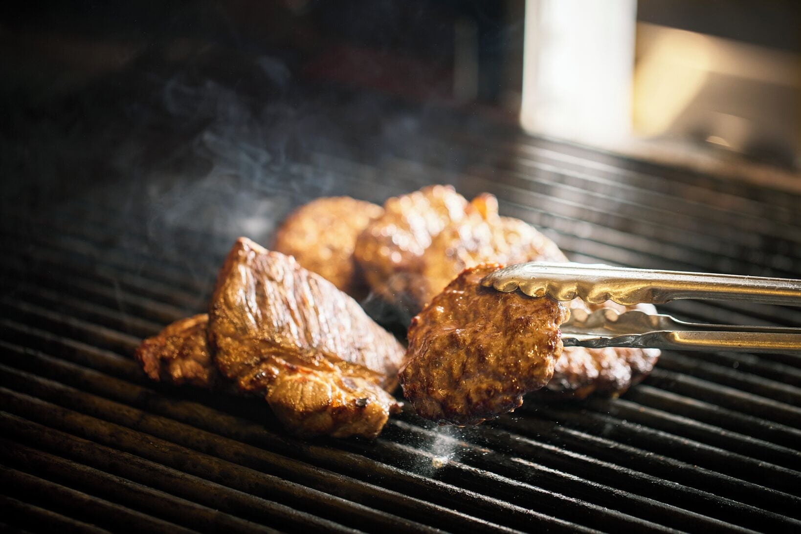 A grill with meat being cooked.