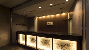 A modern bathroom with a wooden vanity, recessed lighting, and a sign that reads "VILLAGE KYOTO". - Village Kyoto close by Shijo Omiya station (Kyoto)