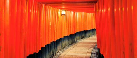 A corridor with red walls and a tiled floor.