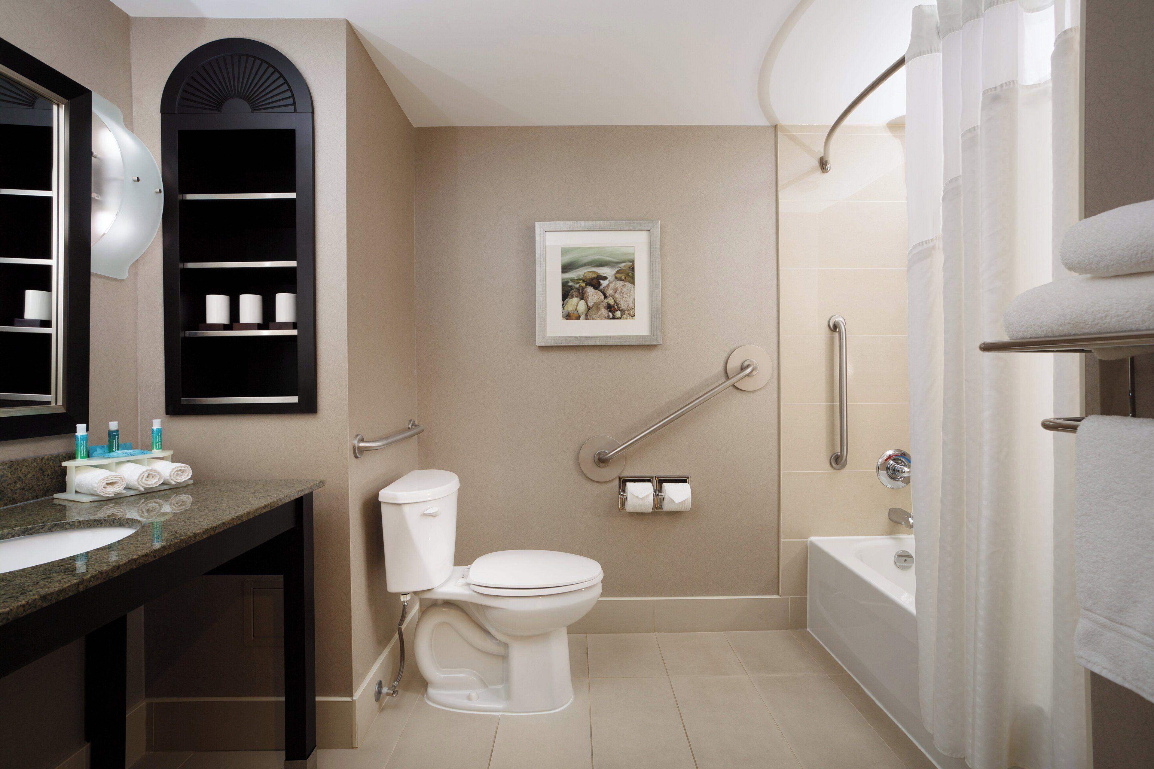 A modern bathroom with a toilet, sink, and shower.
