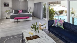 A modern bedroom with a large bed, a sitting area, a balcony with a pool, and a view of the sea. - The Clarendon - Fresnaye (Cape Town)