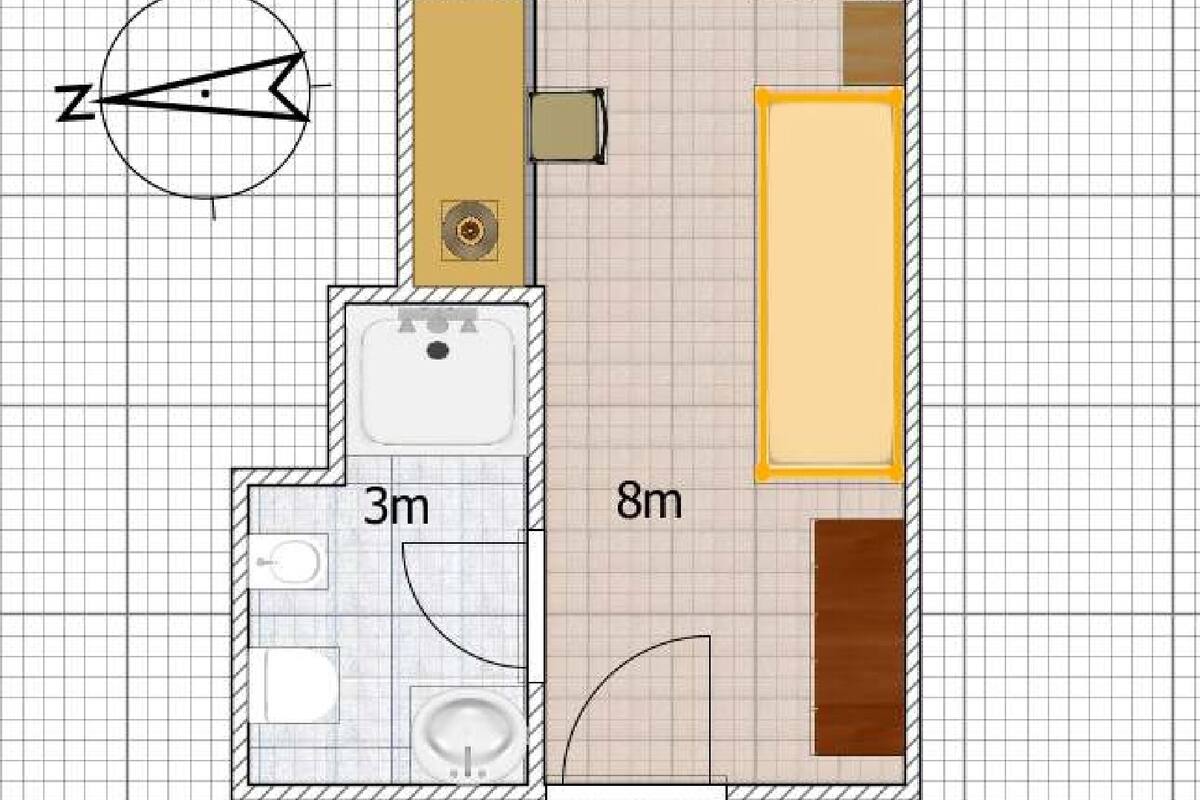 A floor plan with a bathroom, a kitchen, and a living area.