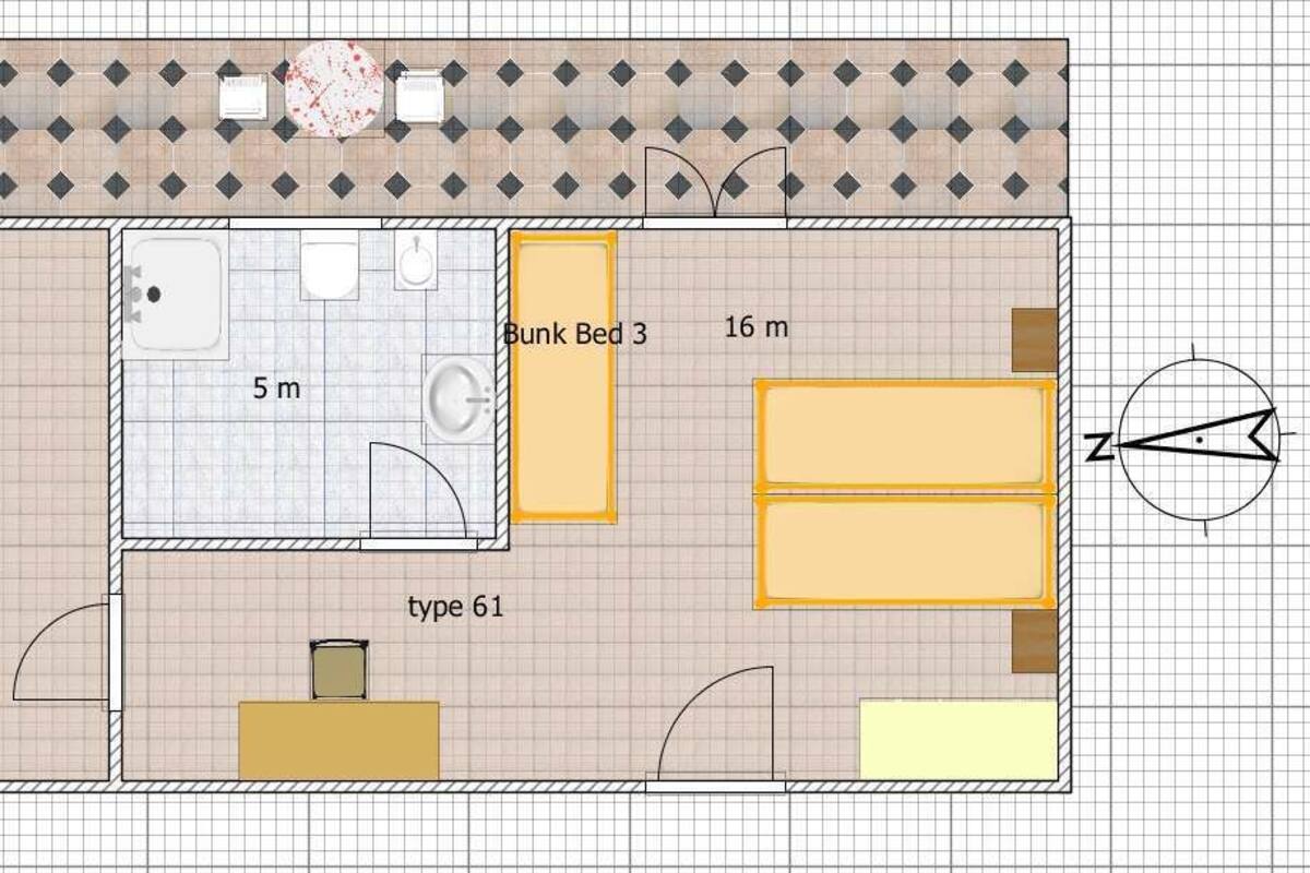 A floor plan of a hotel with three bunk beds, a bathroom, and a kitchenette.