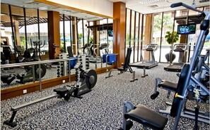 A gym with cardio machines, weight stations, and a mirrored wall. - Royale Chulan Kuala Lumpur (Kuala Lumpur)