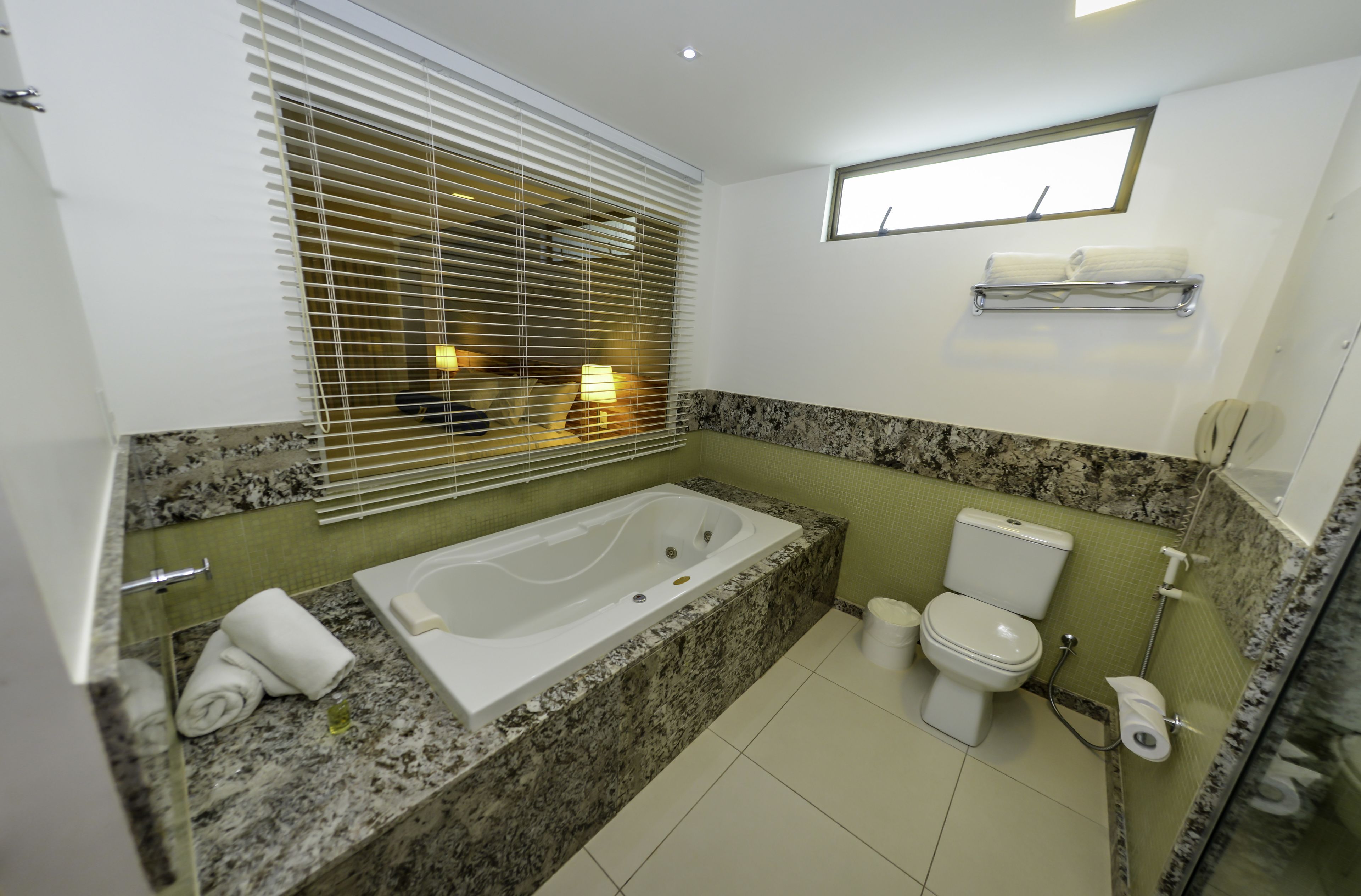 A bathroom with a bathtub, toilet, and sink.