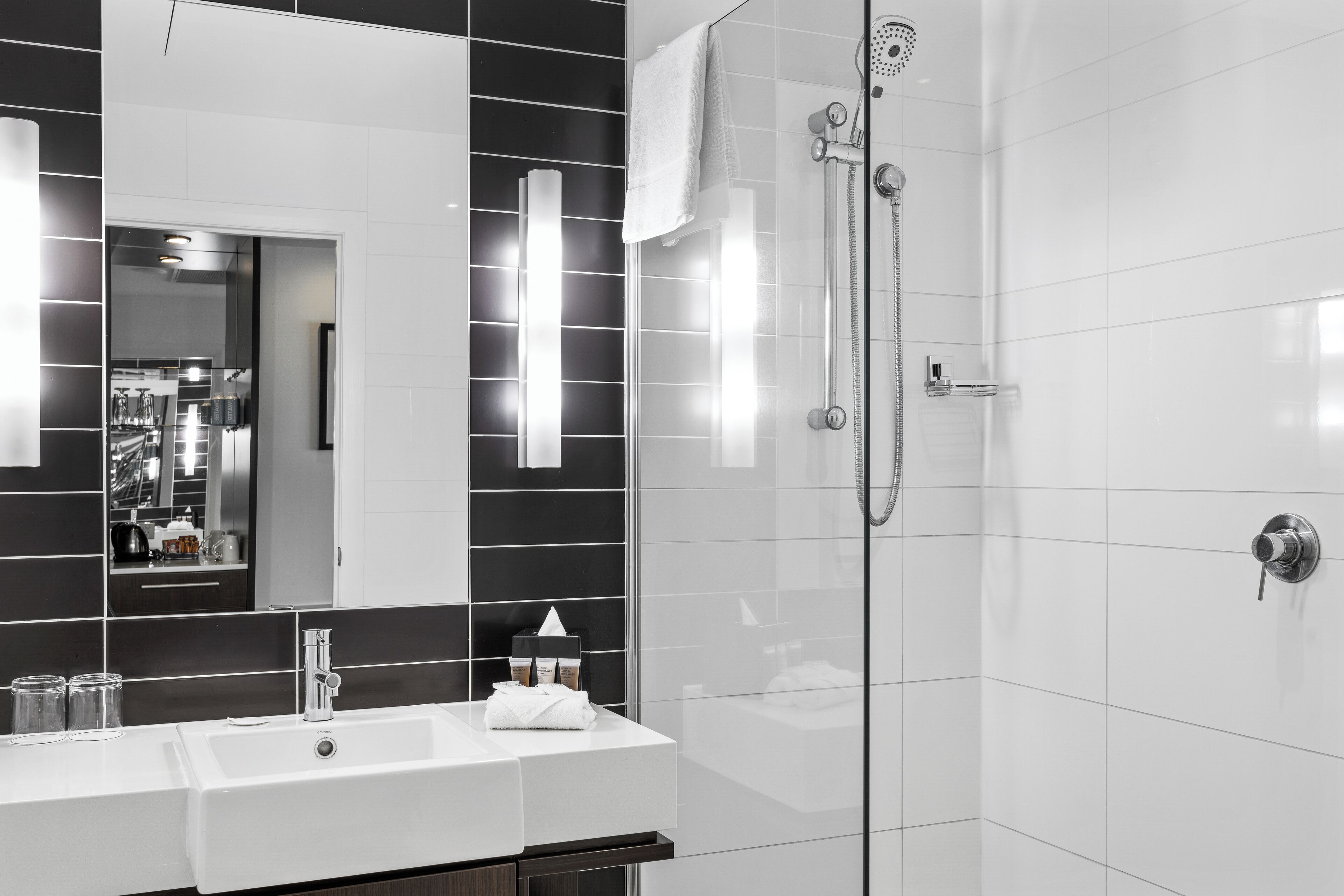 premier twin room, 2 queen beds | bathroom | shower, eco-friendly toiletries, hair dryer, towels