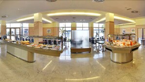 A spacious buffet area with multiple food stations and a central serving counter. - Aparthotel Wellness (Paterna)