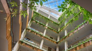A multi-level atrium with a glass ceiling, allowing natural light to illuminate the space. - Boutique SPA Hotel Orchidea (Golden Sands)