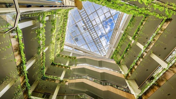 A multi-level atrium with a glass ceiling, surrounded by greenery and modern architecture. - Boutique SPA Hotel Orchidea (Golden Sands)