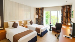 A hotel room with two beds, a desk, a TV, and a balcony with curtains. - Amaranth Suvarnabhumi Hotel - Free Suvarnabhumi Airport Shuttle (Bang Phli)