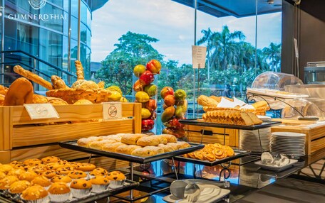 A breakfast buffet with various pastries and fruits.