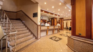 A hotel lobby with a reception desk, a clock, and a staircase. - Klas Hotel Istanbul Old City (Istanbul)
