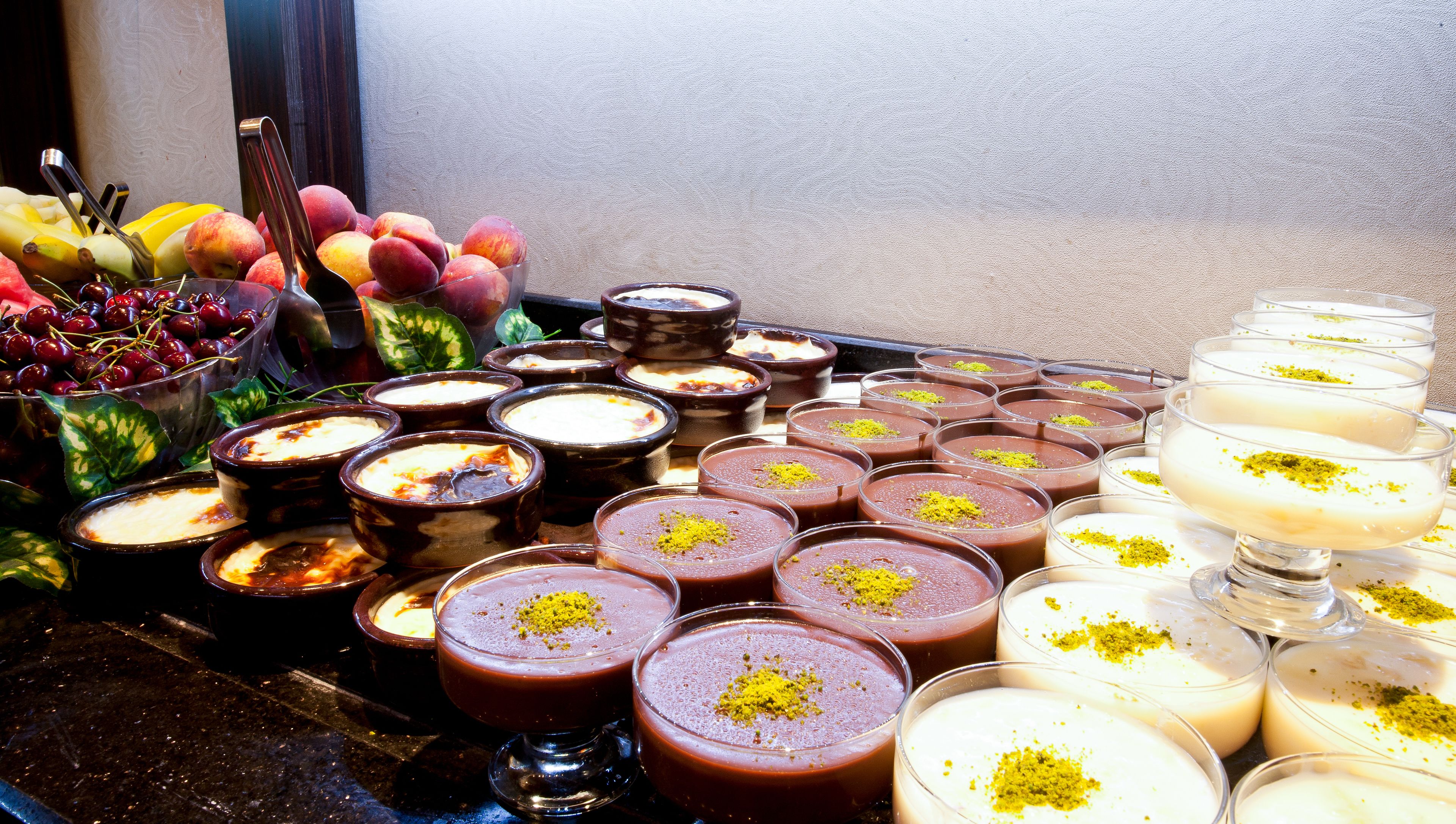 Una variedad de postres, incluyendo platos a base de chocolate y crema blanca, dispuestos en una mesa.