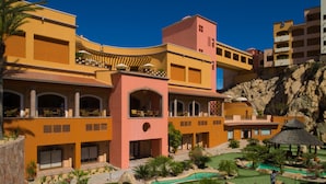 A resort with multiple buildings, a pool area, and a golf course.