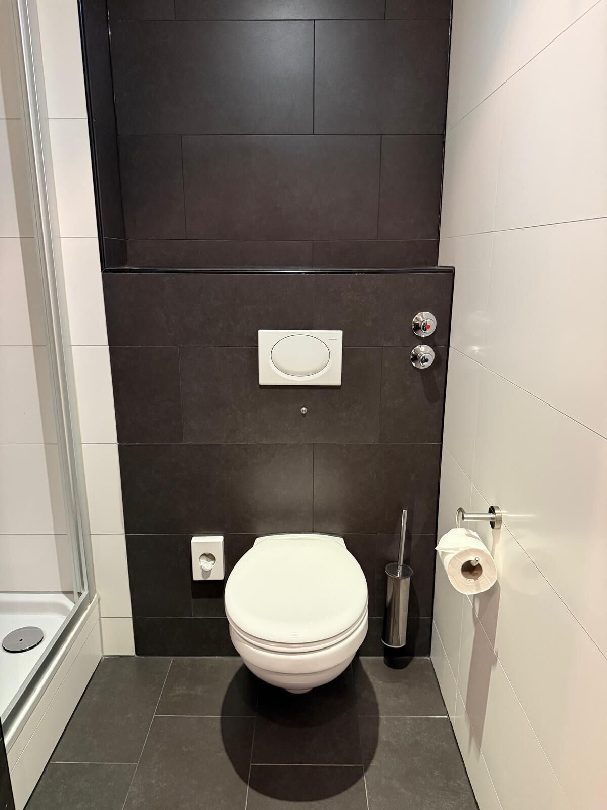 Ein modernes Badezimmer mit Toilette, Bidet und Dusche.