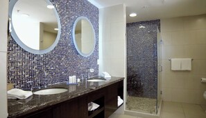 A modern bathroom with two sinks, a large mirror, and a shower area. - Summit Rainforest Golf Resort & All Inclusive (Panama City)