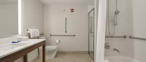 Un baño moderno con ducha, inodoro y lavamanos.