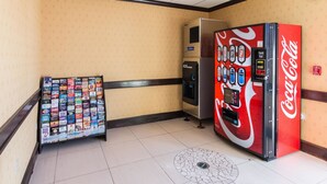 A hallway with a Coca-Cola vending machine and an ice dispenser. - Motel 6 Joshua, TX (Joshua)