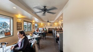 A restaurant with a long counter, booths, and a 'CLOSED' sign on the window.