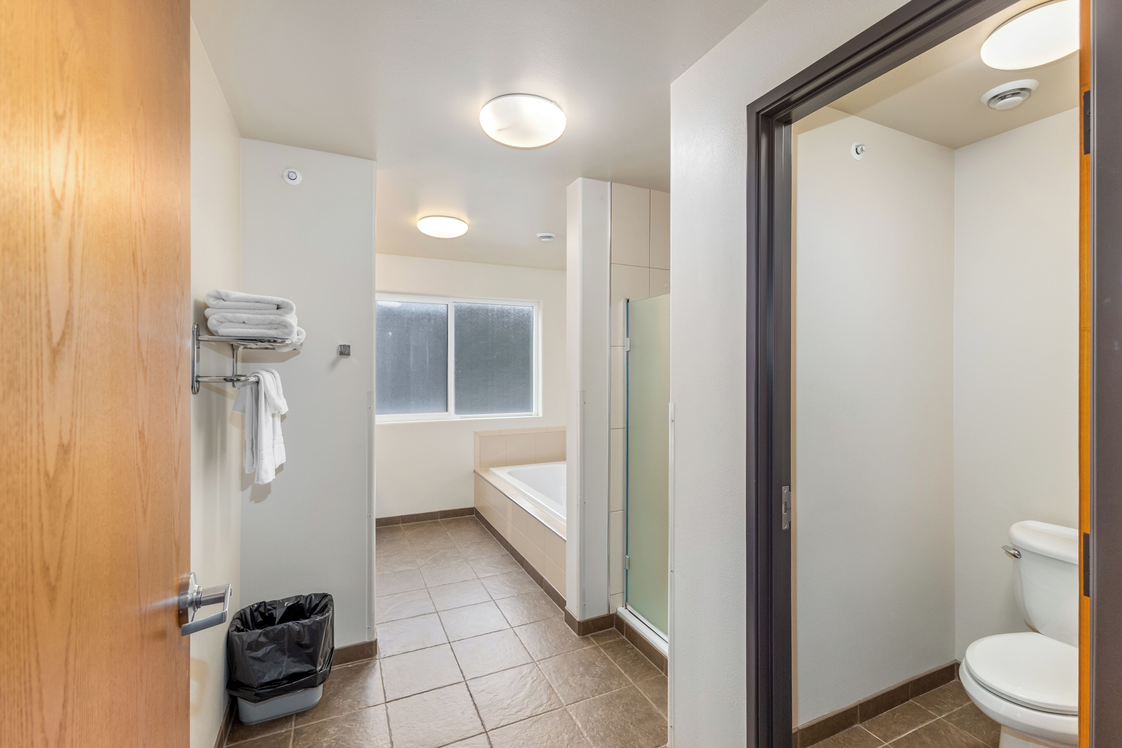 A bathroom with a toilet, a bathtub, and a shower.