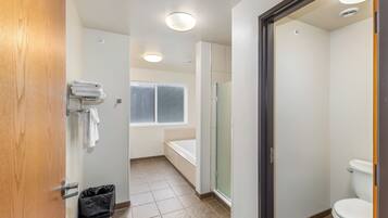 A bathroom with a toilet, a bathtub, and a shower.