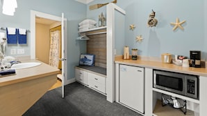 A compact kitchen with a microwave, coffee maker, and a small refrigerator. - Harborview Inn & RV Park (Garibaldi)