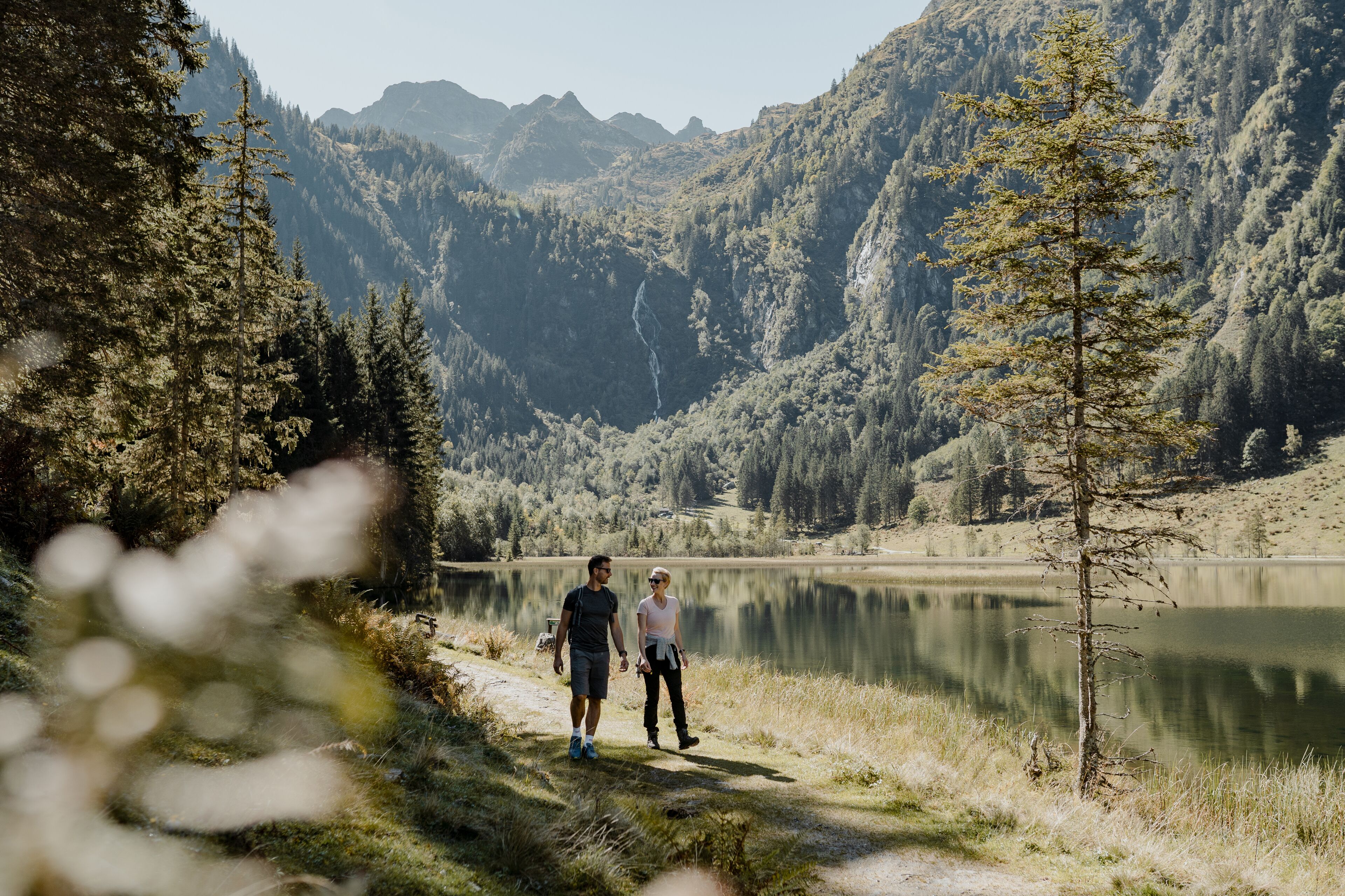 A natural landscape with a lake, mountains, and trees.