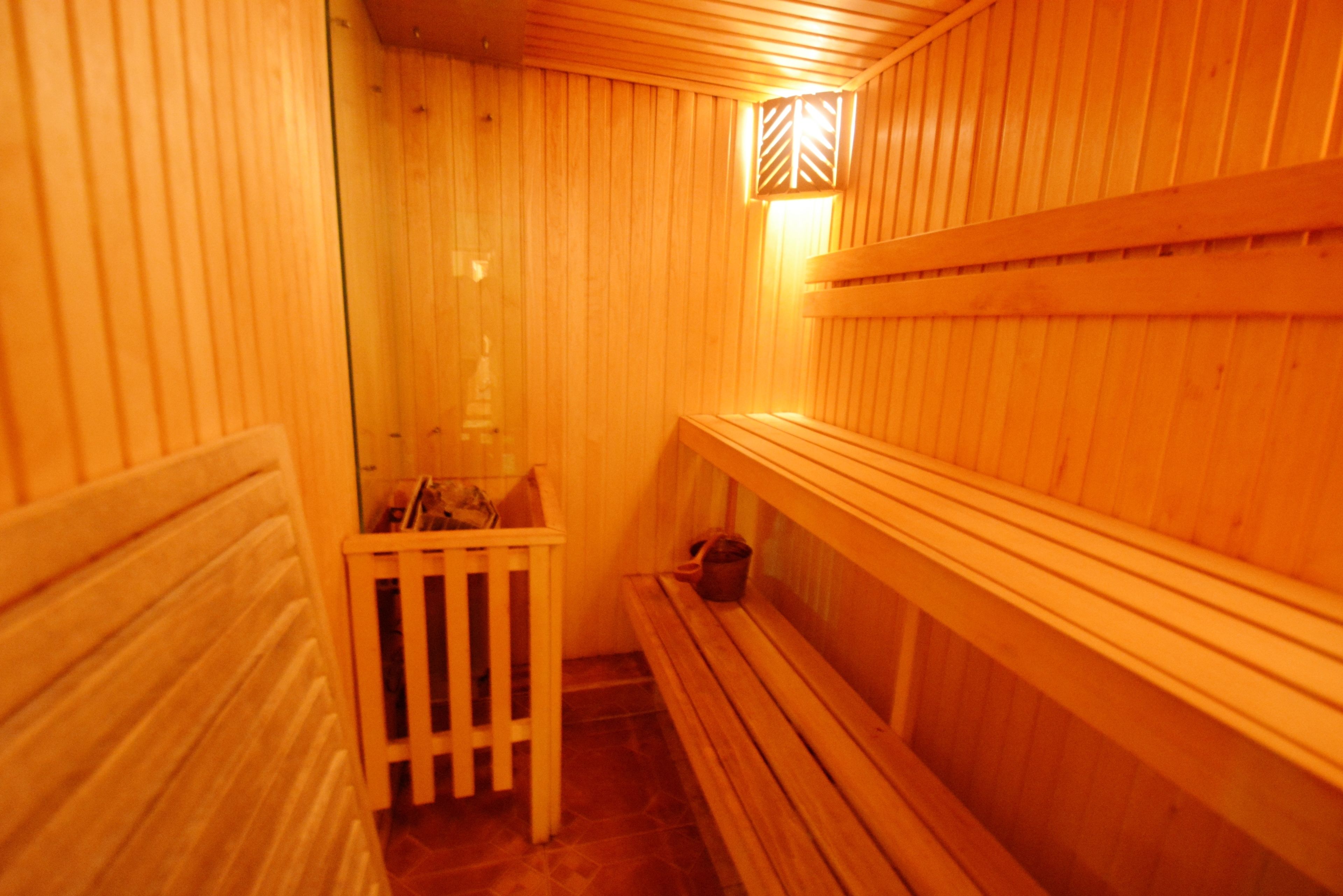 A sauna with wooden walls and benches.