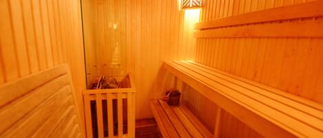 A sauna with wooden walls and benches.