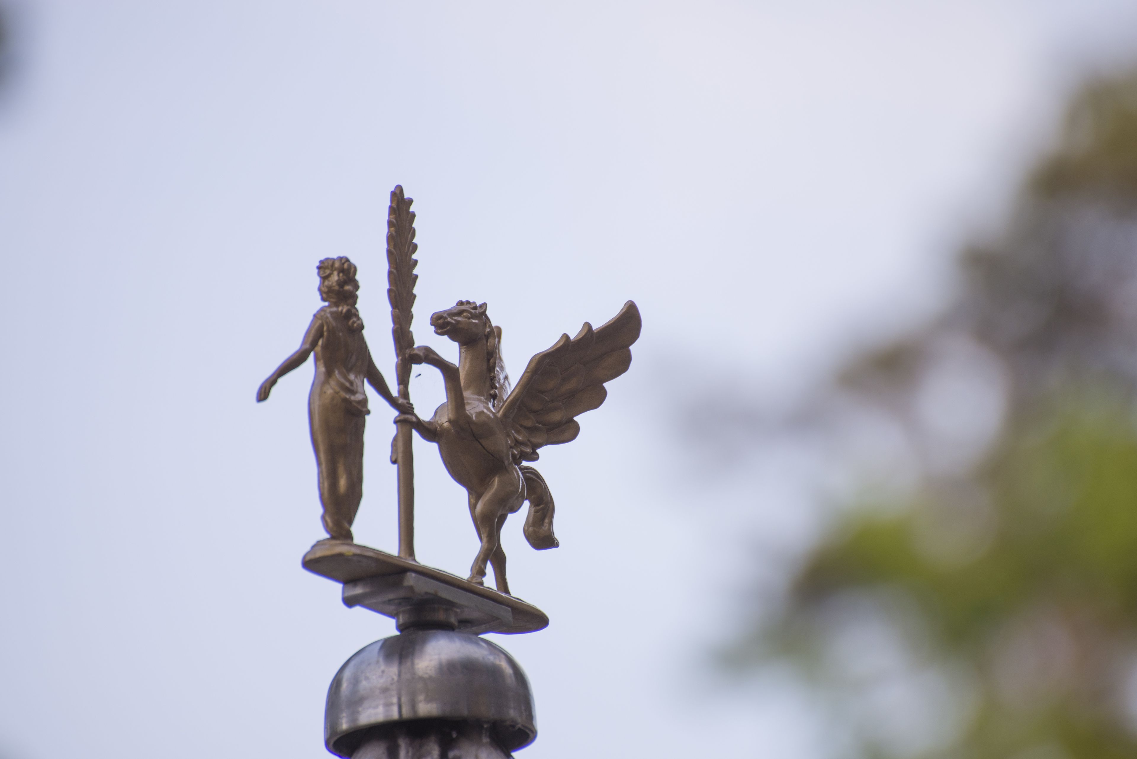 A bronze statue atop a metal structure.