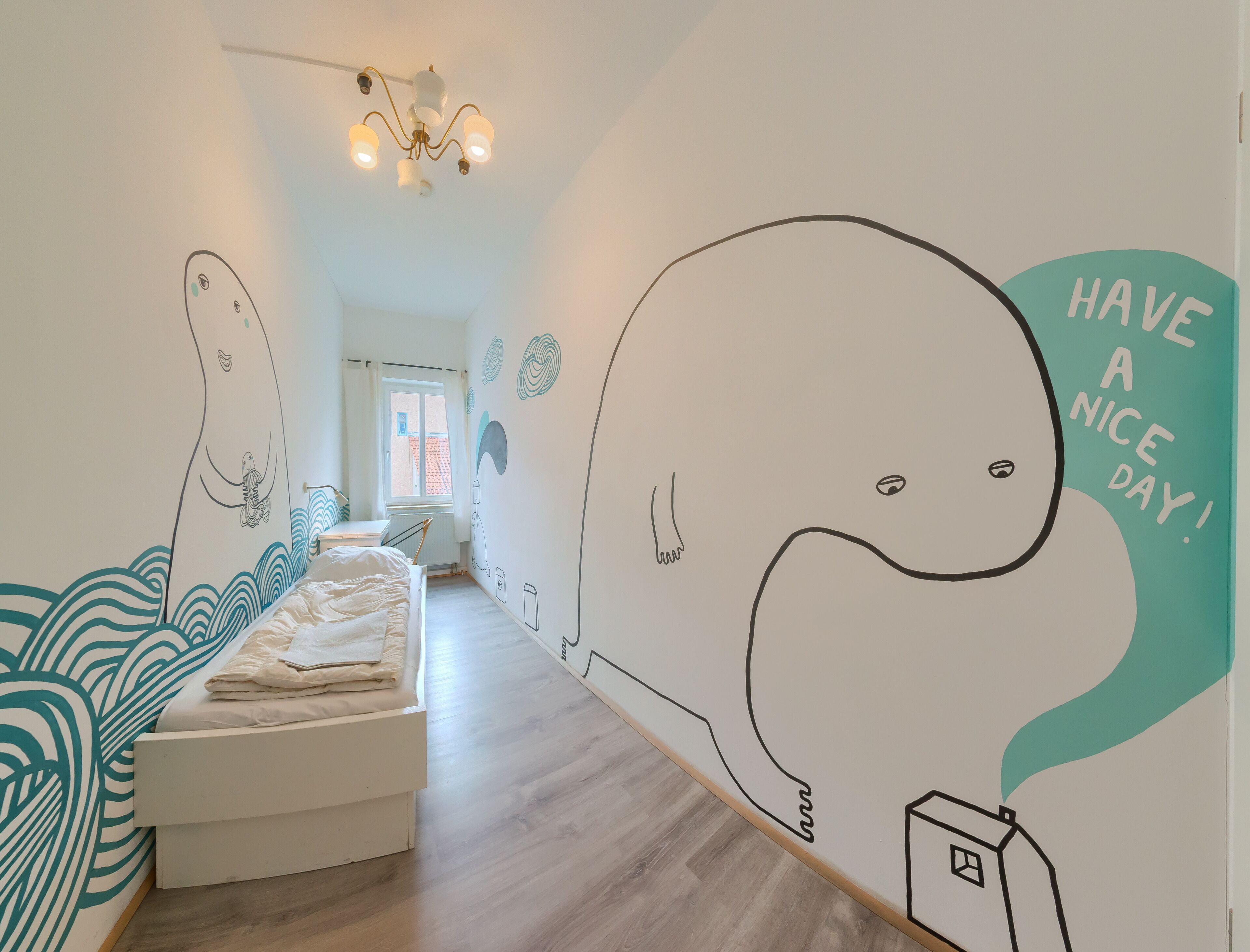 A bedroom with a bed, a window, and a wall with a whale illustration and the text "HAVE A NICE DAY!".