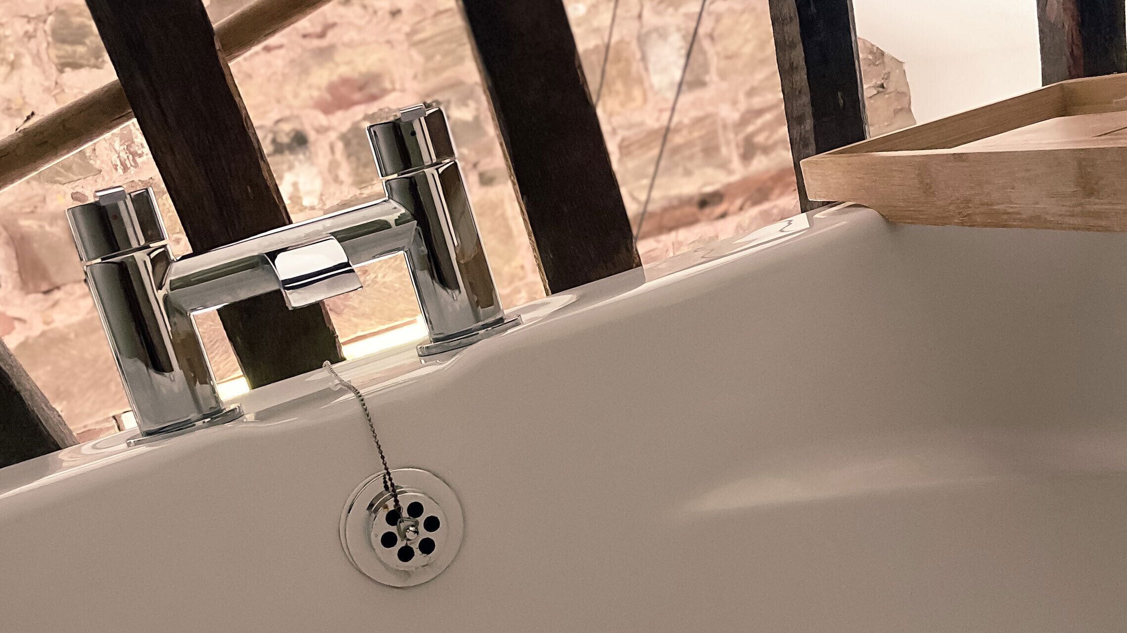 A bathroom sink with chrome fixtures and a visible drain.