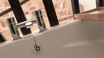 A bathroom sink with chrome fixtures and a visible drain.