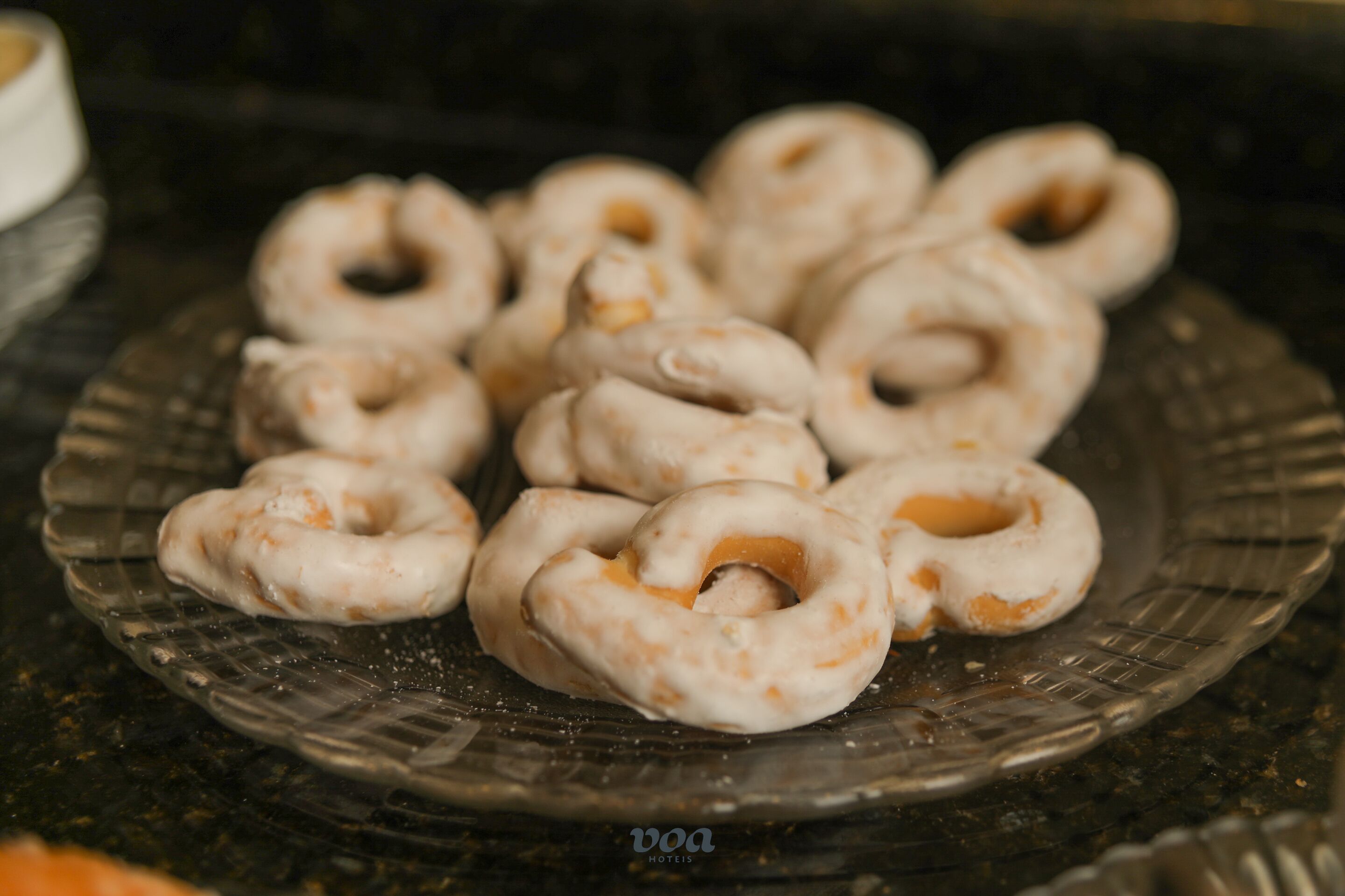 A plate of doughnuts with a glazed coating.