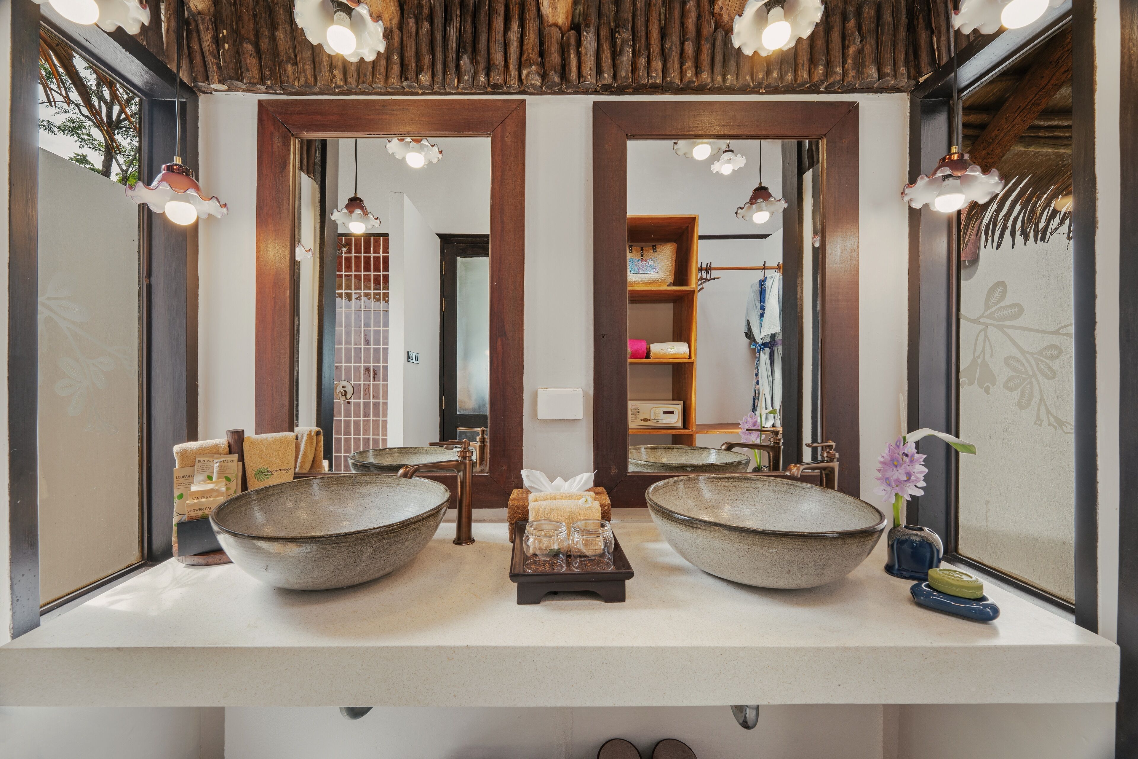 A bathroom with two large ceramic bowls on the counter, a towel rack, and a mirror.