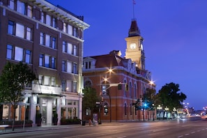 A historic hotel with a prominent clock tower, large windows, and a classic facade.