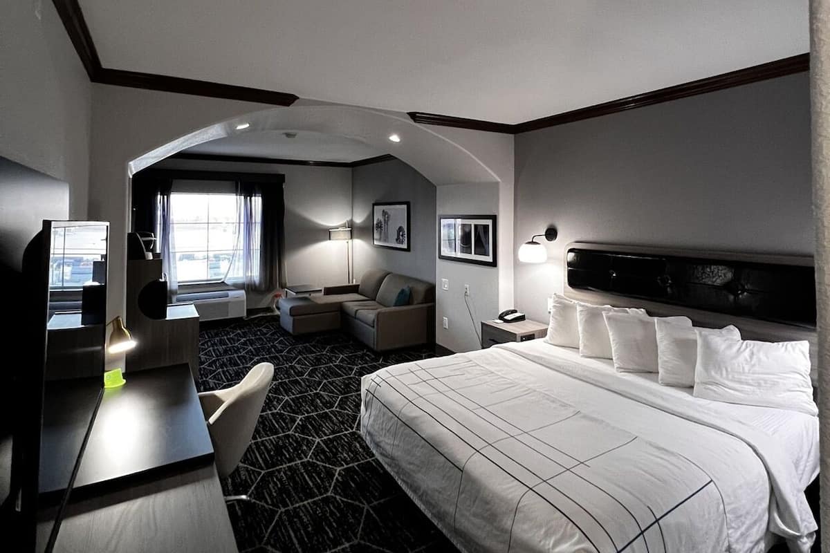 Premium bedding, desk, laptop workspace, blackout drapes
