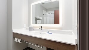 A modern bathroom with a white sink, a mirror, and a towel rack. - Holiday Inn Express & Suites Denton North by IHG (Denton)